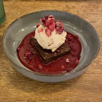 Brownie with strawberry-cheesecake ice cream and raspberry sauce.   at Meet Vegano in Malaga