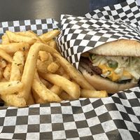 Monthly special Smashburger and golden crispy fries with alkaline water  at Midtown Vegan Deli & Market in Tucson