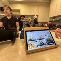 Digital menu on the counter and the small kitchen set up   at Mana Café in Manama