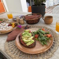 Avocado and tomato toasts and a homemade greek sweet bake (it was our favorite!)  at Ethos Vegan Suites in Santorini