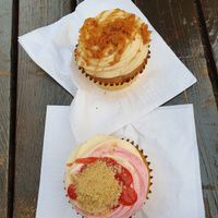 Biscoff cupcake at top of photo and rhubarb and custard cupcake at bottom of photo. at Lola's Cupcakes - Covent Garden in London