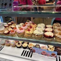 Vegan cupcakes on top row with gold casing  at Lola's Cupcakes - Covent Garden in London