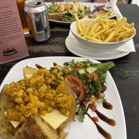 Coronation chickpea baked potato with vegan cheese   at NowNow Cafe in Livingston