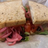 Veggie #1 roasted red peppers, artichokes, red onion, black olives, tomatoes, mixed greens and balsamic vinegar. (We asked to have the provolone removed and add pickled onions)  at Mountain Deli in Hendersonville