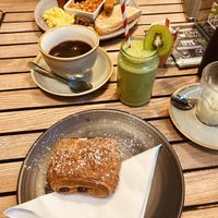 Pain au chocolat and green machine smoothie (full English in the background)  at Cafe@62 in Brighton