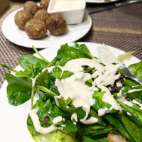 Green salad with tahini, dried bread slices, and hot falafel. Order in advance. at Anoush in Yerevan
