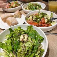 Amazing green salad with quinoa, pear and pomegranate seeds. And a bowl of tomato and cucumber salad. at Anoush in Yerevan