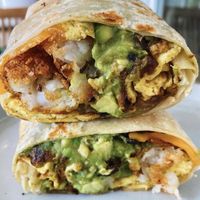 Vegan brekkie burrito with just egg, soyrizo, vegan cheese, tots and guac  at Palmys in San Diego