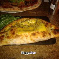 Calzone with cheese on top at Sfizy Veg in Berlin