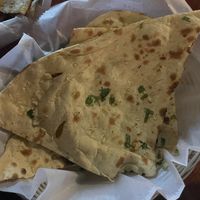Garlic roti and potato paratha in the corner   at Tikka & Grill in Denver