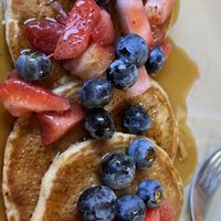 Banana Pancakes with Strawberries, Blueberries and Maple Syrup  at Snooze in San Diego