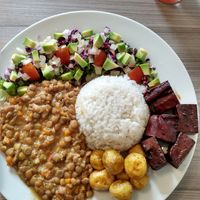 Lentil stew, white rice, tiny potatoes, tofu in soy sauce and a mixed salad. at Marvelous Vegan Plant Power Food in Bogota