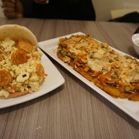 Arepa with Scramble tofu and vegan sausage; stuffed plantain  at Marvelous Vegan Plant Power Food in Bogota