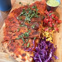Quesadilla Grande dipped in Guajillo sauce  at Penelope's Vegan Taqueria in Chicago