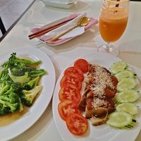 Fried Duck with Peanut sauce and fried broccoli. at Reunion Cafe in Vientiane