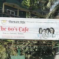 cafe set back off the road in a lovely garden  at The 60's Cafe in Rishikesh