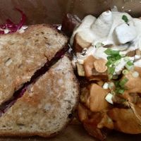 Rueben with potatoes upgrade, and both the mild almond and the cashew chipotle sauces  at cafegSC in Santa Cruz