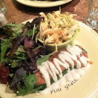 Raw enchilada with sprouted seed filling, spicy mole, cashew sour cream and scallions served with a spicy Mexican coleslaw and salad at cafegSC in Santa Cruz