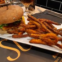 Smoky burger -Heura brand patty- and sweet potato fries at Restaurant Sublime World in Madrid