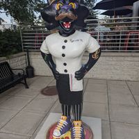 Outdoor seating area visible behind the pizza panther at Urban Pie in Cedar Falls