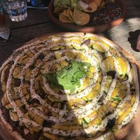 Creamy mushroom pizza $26 (large) and nachos $21 at Mandala & Co in Mermaid Beach