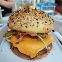 Vegan burger with vegan cheddar, grilled zucchini, salad, fried onions & something like a beyond burger patty at Le Sunset-Nice in Nice