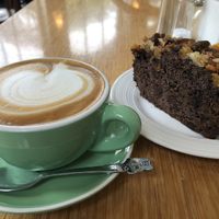 Soy latte and vegan chocolate date apricot cake at The Good Earth Cafe in Dunedin