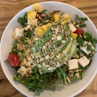 DH custom bowl with rice, greens, tofu, edamame, mango, tomatoes and lots of yummies!   at Sunflower in Foley