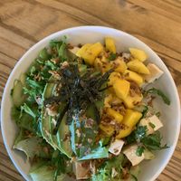 My favorite bowl with rice, greens, tofu, edamame, cilantro, cucumber, mango, avocado, seaweed salad, crispy onions and crispy seaweed - soooooo good!  at Sunflower in Foley