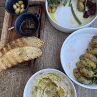 A big old bowl of hummus served with sourdough, oil and olives   at Ronda in Rhodes