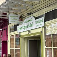 Restaurant sign with a small table and 3 chairs   at Ratana's in Hilo