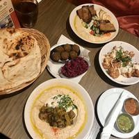 Selection of hummus, bread, falafel, cabbage, and cauliflower at Hummus Bar - Oktober in Budapest