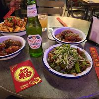 Korean wings and blackbean udon noodles.  In the background spiced tofu fries and another portion of wings. at Hello Oriental in Manchester