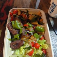 Coconut rice, vegan chicken, bell pepper and sweet fried plantain. Avocado sauce on top. Salad on the side. at Tatashe in Aarhus