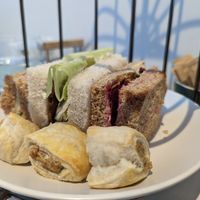 Cucumber + cream cheese, Seitan + lettuce + tomato, beetroot + hummus + crispy onion sandwiches, local handmade vegan sausage rolls. at Hamilton's Tea House in Farnham