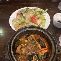 Tofu with seaweed and pineapple in claypot, and soy chicken noodles at the back   at Tinh Tam Vegan in Hue