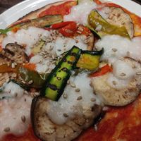 Vegan pizza with almond cheese at Rajas Cafe in Merone