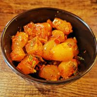 Pickled leek and radish with smoky chili sesame oil and fresh herbs at The Real Wan in Glasgow