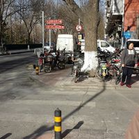 Turn right into the lane. This sign is about 50m from the Dong'anmen corner. The red sign on the pole clearly labels the way to get there at Fu Hui Ci Yuan Vegetarian Restaurant in Beijing