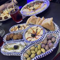 Fatima’s plate, one “finger” is labneh (not vegan). Hummus plates with falafel & chickpea salad  at Arabeska in Bratislava