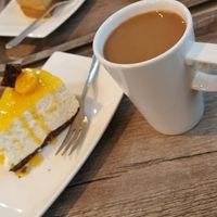 Mango cake and coffee at Cake House Café in Tampere