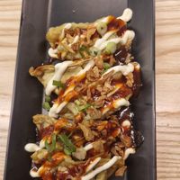 mega korean gyoza vegetable: Veggie gyoza topped with Korean ketchup, shichimi, mayo, crispy & spring onions at Yo! Sushi - Trafford in Manchester