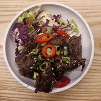 Pulled shiitake teriyaki in a sticky soy glaze, topped with sesame and a fresh chilli garnish. Served with a citrus slaw at Yo! Sushi - Trafford in Manchester