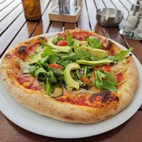 Tomato sauce, vegan cheese, corn, beans, zucchini, arugula, cherry tomatoes, avocado at Picerija Gajbica in Ravne Na Koroskem