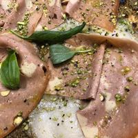 Vegan mortadella, rice mozzarella, and pistachio cream pizza at Assaje in Turin