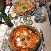 Top pizza is vegan. It's pistachio pesto, vegan cheese and mock meat. at Assaje in Turin