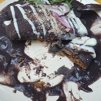 Enfrijoladas veganas deliciosas. Rellena de verduras bañada con queso vegano y frijoles at La Otilia - Polanco in Mexico City