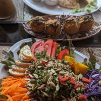 Back to front: iced oat latte, vegan quesadilla, fried (cashew) "cheese" balls, rainbow salad. at Poke Bowl in Koh Chang