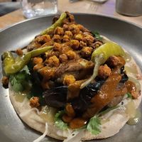 Flatbread kebab (Pickled White Cabbage, Picked Herbs, Green Apple & Jalapeno Sauce, Pickled Chillis) with Moroccan Spiced Aubergine, Charred Tomato & Garlic Ketchup, Roasted Chickp at Pint Shop in Cambridge