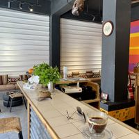 Sitting at the bar  at Frankfurter Supermarket & Cafe in Madaba